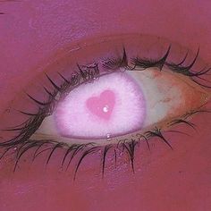 a pink eye with long lashes and a heart on it