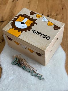 a wooden box sitting on top of a white fur rug next to a name tag