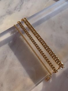 "* High quality 24k gold filled Cuban link chain bracelet * Choose from three chain sizes; petite, medium or bold curb chain * Customizable length from 6.5\" - 7.5\" * Handmade in SB, California * Expected shipping 4-7 business days" Gift Curb Chain Bracelet With Rectangular Links, Everyday Gold Bracelets With Curb Chain, Everyday Gold Curb Chain Bracelet, Gold Curb Chain Bracelets For Everyday, Gold Curb Chain Bracelet For Everyday, Gold-plated Cuban Link Chain Bracelet, Gold Plated Cuban Link Chunky Chain Bracelet, Gold Oval Link Figaro Chain Bracelet, Gold-plated Curb Chain Bracelet