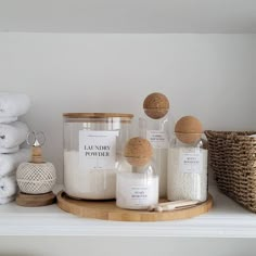 a shelf with candles, towels and other items on it