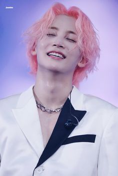 a woman with pink hair wearing a white shirt and black tie