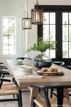 a dining room table with plates and bowls on it