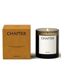 a black candle next to a box on a white background with the word,'chaper '