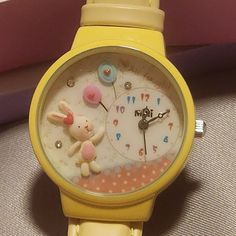 This Mini Brand Handcrafted Watch Is A Unique Timepiece That Features A Bunny & Balloon Theme. The Hand Created And Hand Painted Decorations On The Front Of The Watch Includes A White Standing Bunny With Pink Accents With Two Balloons In Pink And Blue With Red Hearts On The Balloons. There Are Also Three Crystals As Additional Accents And "All For You" Printed On The Face Of The Watch. The Watch Has A Round Shape And A Yellow Band Made Of Faux-Leather. The Face Features Multicolored Arabic Numer Cute Wrist Watch, Cute Collectibles, Bunny Balloon, Bunny Clothes, Standing Bunny, Mickey Watch, Balloon Theme, Gold Michael Kors Watch, Face Features