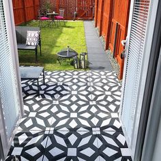 an outdoor patio with black and white tiles