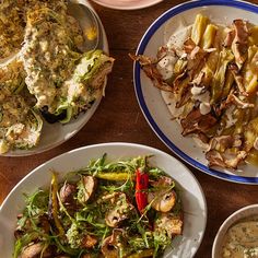 several plates of food on a wooden table