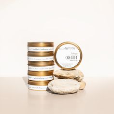 a stack of gold coins next to a pile of white rocks and a round label