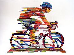 a man riding a bike on top of a white surface with multicolored lines