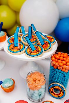 a table topped with lots of cupcakes and candy