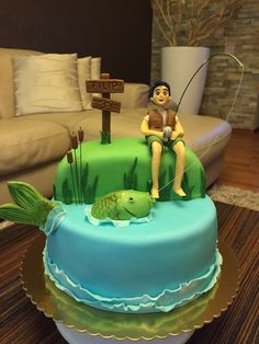 there is a cake with a fishing theme on the top and a fish in the middle