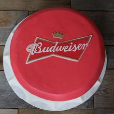 a red cake with the word budweiser on it and a crown on top