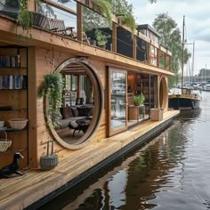 a houseboat is docked in the water with bookshelves on it's sides