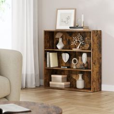 a living room with a couch, coffee table and bookshelf on the floor