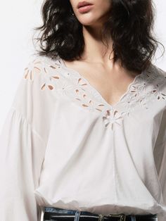 MO&Co. Women's Volume Sleeves Cotton Blouse Made from 100% cotton, this blouse is soft, breathable, and comfortable to wear. Designed with a charming Broderie Anglaise design, the V-neckline adds a touch of elegance, while the volume sleeves add a playful, modern twist. Pair it with your favorite jeans or a skirt for a chic look. Features : - Regular fit- V-neckline and volume sleeves- Delicate broderie anglaise design Code: MBD2TOPT52The back length of size S is 50.3cmMATERIALS & CARE Material: Chic Cotton Blouse With Cutwork Hem, Feminine Cotton V-neck Blouse, Cotton V-neck Blouse With Floral Embroidery, Cotton Blouse With Cutwork Hem For Daywear, Chic Long Sleeve Tops With Cutwork Hem, Long Sleeve Blouse For Daywear With Cutwork Hem, Long Sleeve Summer Tops With Cutwork Hem, Summer Long Sleeve Tops With Cutwork Hem, Spring Daywear Blouse With Cutwork Hem