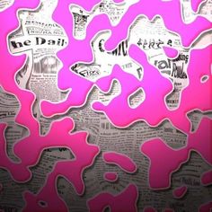 pink and black paper cut into shapes with newspaper clippings in the middle on a wall