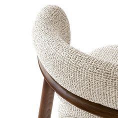 the back of a chair with a wooden armrest and seat cushion on white background