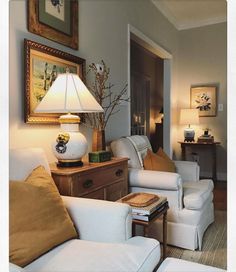 a living room filled with furniture and a lamp