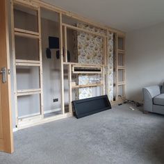 a living room that is being remodeled with wood framing and wallpapers on the walls