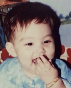 an old photo of a young boy eating something