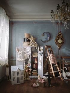 a room filled with lots of clutter and toys on top of a wooden floor