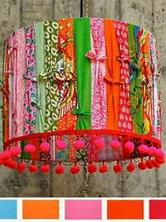 a colorful chandelier with pom poms hanging from it's side