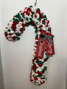 a christmas wreath hanging on the front door