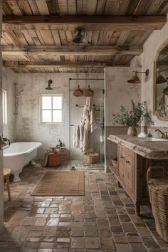 a rustic bathroom with stone flooring and exposed wood ceiling, along with an antique bathtub