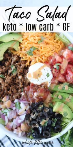 taco salad with lettuce, tomatoes, black beans, cheese and avocado