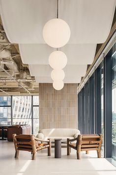 an office lobby with modern furniture and large windows