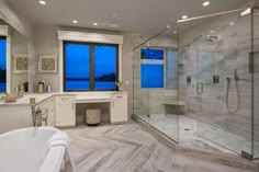 a large bathroom with a walk in shower next to a bathtub