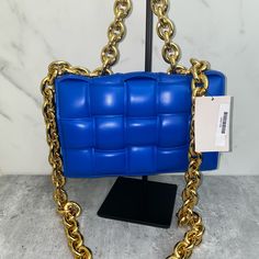 Padded Intrecciato Leather Crossbody Bag One Interior Zipped Pocket Metal Closure Material: 100% Lambskin Lining: Bonded Lambskin Color: Cobalt (Blue) Hardware: Gold Finish Height: 18 Cm | 7.1" Width: 26 Cm | 10.2" Depth: 8 Cm | 3.1" Handle Drop: 13 Cm | 5.1" Strap Drop: 50 Cm | 19.7" Made In: Italy Product Code: 631421vbwz08425 Comes With Dust Bag No Box Never Carried Never Used! Comes From A Smoke Free Pet Free Environment Luxury Blue Bag With Chain Detail, Luxury Blue Bags With Chain Detail, Luxury Blue Bags With Chain, Luxury Blue Chain Bags, Luxury Blue Square Shoulder Bag, Blue Rectangular Bag With Chain Detail, Blue Rectangular Bag With Chain, Blue Rectangular Bags With Chain, Formal Blue Bag With Chain