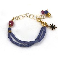 Glittering, vibrantly hued genuine polished natural periwinkle hued tanzanite, one of the rarest and most prized of all gemstones, sparkles on this strand in a beautiful bright striking splash of color! A plump faceted pink sapphire accents the side of the wrist. 14k gold fill chain and colorful drop embellishments add a little chic bling. l Blue Tanzanite Gemstone Bracelets, Blue Amethyst Beaded Bracelets As Gift, Blue Amethyst Beaded Bracelets For Gift, Handmade Blue Amethyst Bracelets, Blue Tanzanite Bracelet Jewelry, Blue Amethyst Bracelets With Natural Stones, Tanzanite Gemstone Bracelet Jewelry, Fine Jewelry Blue Amethyst Jewelry, Fine Jewelry In Blue Amethyst