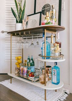 a bar cart filled with bottles and glasses