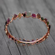 GemFormingStudio D E T A I L S Tourmaline Bangle | Rough Stone Bangle | Gemstone Bangle | Handmade Bangle | Brass Bangle | Brass Jewelry | New Design | Gift For Women Stone Size : 11 X 7 mm ( Approx ) Weight : 16.49 gm Bangle Size : 2.5 inches Color : Red , Green Material : Brass Polish : Rose Gold Polish . Contact us for wholesale prices. R I N G S https://www.etsy.com/in-en/shop/GemFormingStudio?section_id=22783374 B E A D S https://www.etsy.com/in-en/shop/GemFormingStudio?section_id=22828835 Rough Stone Ring, The Bangles, Brass Bangle, Gemstone Bangle, Tourmaline Bracelet, Electroformed Jewelry, Stone Bangle, Handmade Bangles, Fashion Goals