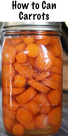 a jar filled with carrots sitting on top of a wooden table