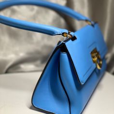 This Trapezoid Bag Is A Style Maker. Gorgeous Calf Leather With Signature Gancini Closure, 8" Drop Handle, Exterior Pocket, 2 Interior Pockets And Bun Feet. I Bought It To Go With A Dress And Ended Up Wearing Something Else. Classic Blue Crossbody Flap Bag, Blue Leather Flap Bag With Gold-tone Hardware, Blue Top Handle Shoulder Bag For Evening, Luxury Blue Flap Bag With Gold-tone Hardware, Chic Blue Leather Flap Bag, Elegant Blue Shoulder Bag With Fold Over Clasp, Blue Evening Shoulder Bag With Top Handle, Classic Blue Evening Bag, Designer Satchel With Fold Over Clasp And Double Handle