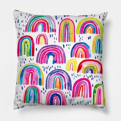 a white pillow with rainbows painted on it