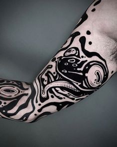 a man's arm covered in black and white ink with an octopus on it