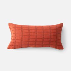 an orange and black checkered pillow on a white background with the words,'home is