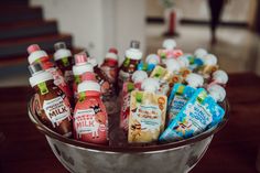 a metal bowl filled with lots of different types of condiments