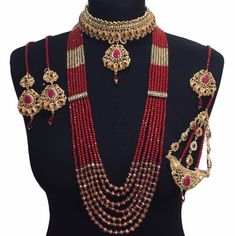 a mannequin with red and gold beads on it