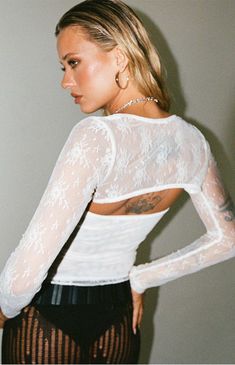 Elevate your style with the Ashwood Shrug & Tube Top Two Piece Set from Princess Polly, featuring a sheer lace long-sleeve bolero paired with a chic strapless tube top. This versatile set offers effortless elegance, perfect for adding a touch of sophistication to any ensemble.

Sizing: XXS (US 0 / AU 4), XS (US 2 / AU 6), SML (US 4 / AU 8), MED (US 6 / AU 10), LRG (US 8 / AU 12), XL (US 10 / AU 14), XXL (US 12 / AU 16)


	Includes shrug and tube top
	Bolero: sheer lace bolero
	Tube top: strapless, cropped length
	Mesh lined top
	Good stretch
	Lace trim
	90% reclaimed nylon, 10% spandex
	Model is wearing a size US 4
	This item was created with reclaimed nylon, a high quality material that’s designed to be long lasting and lower impact.
	Learn more about PacSun eco items Festival Tops Women, Womens Party Tops, Bolero Top, White Top Women, Lace Bolero, Womens Knit Tops, Strapless Crop Top, Lace Bandeau, Coachella Outfit