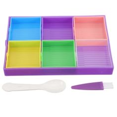 an assortment of colorful trays with spoon and utensils