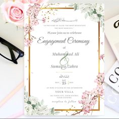 a wedding card with flowers on it next to some cards and eyeglasses,