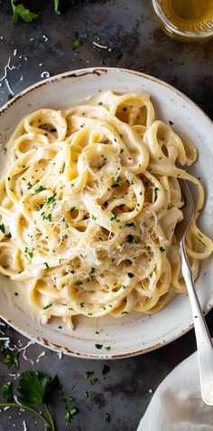 a white plate topped with pasta and parsley