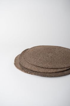 two round placemats sitting on top of each other