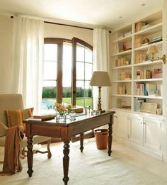 a living room filled with furniture next to a window