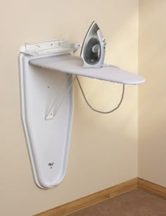 an ironing board mounted to the side of a wall