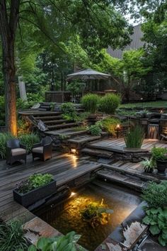 an outdoor garden with steps leading up to the deck and water feature in the center