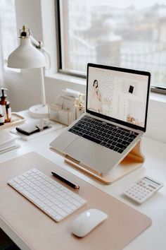 an open laptop computer sitting on top of a desk next to a mouse and keyboard